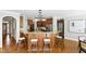 Kitchen area with hardwood floors, breakfast bar, stainless steel appliances, and pendant lighting at 307 Beacon Falls Ct, Cary, NC 27519