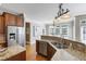 Well-lit kitchen with stainless steel appliances, granite countertops, and hardwood floors at 307 Beacon Falls Ct, Cary, NC 27519
