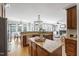 Open kitchen design with breakfast bar, stainless steel appliances, and views of the living spaces at 307 Beacon Falls Ct, Cary, NC 27519