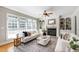 Bright living room with hardwood floors, large windows, fireplace, and comfortable seating at 307 Beacon Falls Ct, Cary, NC 27519