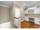 A view of a landing with built in desk and shelves and hardwood floors at 307 Beacon Falls Ct, Cary, NC 27519