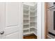 Walk-in pantry featuring ample shelving for storage and organization next to oven appliance at 307 Beacon Falls Ct, Cary, NC 27519