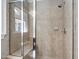 Walk-in shower with glass enclosure, tiled walls, and a built-in seat at 307 Beacon Falls Ct, Cary, NC 27519