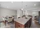 Bright open-concept kitchen featuring an island, stone countertops, and stainless steel appliances at 333 Amber Acorn Ave, Raleigh, NC 27603