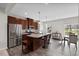 Well-appointed kitchen with island, stainless steel refrigerator, and breakfast bar at 333 Amber Acorn Ave, Raleigh, NC 27603