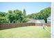 Wide shot of large, well-maintained backyard with wooden fence on a sunny day at 4125 Scofield Dr, Raleigh, NC 27610