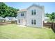 Exterior shot of house showing a well maintained lawn, wooden fence and concrete patio at 4125 Scofield Dr, Raleigh, NC 27610