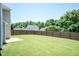 Wide shot of large, well-maintained backyard with wooden fence on a sunny day at 4125 Scofield Dr, Raleigh, NC 27610