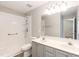 Bathroom featuring double vanity, accessible shower, and bright lighting fixtures at 4125 Scofield Dr, Raleigh, NC 27610