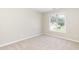 Bedroom featuring neutral carpet, large window, and ample natural light at 4125 Scofield Dr, Raleigh, NC 27610