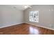 Bedroom featuring vaulted ceiling, hardwood floors, and natural light from the window at 4125 Scofield Dr, Raleigh, NC 27610