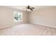 Bright bedroom features neutral carpet, a window with natural light, and a ceiling fan at 4125 Scofield Dr, Raleigh, NC 27610
