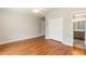 Bedroom with hardwood floors, a closet, and a doorway leading to the bathroom at 4125 Scofield Dr, Raleigh, NC 27610
