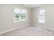 Bedroom featuring neutral carpet, large windows, and ample natural light at 4125 Scofield Dr, Raleigh, NC 27610