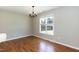 Bright dining area featuring hardwood floors, chandelier lighting, and a large window at 4125 Scofield Dr, Raleigh, NC 27610