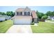 Charming two-story home featuring neutral siding, a well-manicured lawn, and an attached two car garage at 4125 Scofield Dr, Raleigh, NC 27610