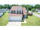 Charming two-story home featuring neutral siding, a well-manicured lawn, and an attached two car garage at 4125 Scofield Dr, Raleigh, NC 27610