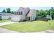 Charming two-story home featuring neutral siding, a well-manicured lawn, and an attached two car garage at 4125 Scofield Dr, Raleigh, NC 27610