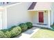 Charming front entrance with a red door, neat shrubbery, and a well-maintained walkway at 4125 Scofield Dr, Raleigh, NC 27610