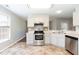 Bright kitchen featuring stainless appliances and neutral finishes at 4125 Scofield Dr, Raleigh, NC 27610