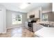 Open kitchen with stainless steel appliances and access to the backyard at 4125 Scofield Dr, Raleigh, NC 27610