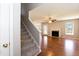Open-concept living room with a fireplace, hardwood floors, and ample natural light at 4125 Scofield Dr, Raleigh, NC 27610