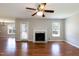 Bright living room with a fireplace, hardwood floors, and a view to the backyard at 4125 Scofield Dr, Raleigh, NC 27610