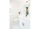 Clean, white bathroom featuring a modern vanity, stylish faucet, and a well-lit mirror at 415 E Lavender Ave, Durham, NC 27704