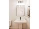 Clean bathroom with a pedestal sink, modern mirror, and stylish towel rack at 415 E Lavender Ave, Durham, NC 27704