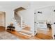 Inviting entryway with hardwood floors, staircase, and a glimpse into a light-filled bedroom at 415 E Lavender Ave, Durham, NC 27704