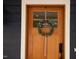 Close-up of a wood front door with glass pane and a wreath at 415 E Lavender Ave, Durham, NC 27704