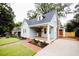 Charming home featuring a covered front porch, brick walkway, and a manicured lawn at 415 E Lavender Ave, Durham, NC 27704