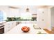 Well-lit kitchen with white cabinets, stainless appliances, a farmhouse sink, and a large center island at 415 E Lavender Ave, Durham, NC 27704