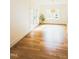 Bright living room boasts hardwood floors, large windows, and glass doors at 415 E Lavender Ave, Durham, NC 27704