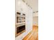 Gourmet kitchen with stainless steel double ovens and custom white cabinetry at 415 E Lavender Ave, Durham, NC 27704