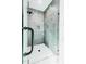 Modern shower stall featuring gray tiling, matte black hardware, and a built-in shelf at 415 E Lavender Ave, Durham, NC 27704