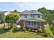 Spacious backyard featuring a screened porch, open deck, and a pergola with solar panels on the roof at 4219 Peachway Dr, Durham, NC 27705