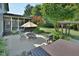 Outdoor patio with an umbrella-covered table, chairs, grill and a deck, perfect for entertaining at 4219 Peachway Dr, Durham, NC 27705