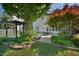 Lush backyard featuring a brick patio, pergola, and well-maintained landscaping, offering a serene outdoor space at 4219 Peachway Dr, Durham, NC 27705