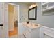 Well-maintained bathroom features a white vanity and mirror with decorative lighting at 4219 Peachway Dr, Durham, NC 27705