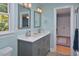 Bright bathroom features a double vanity with gray cabinets and a white countertop at 4219 Peachway Dr, Durham, NC 27705
