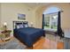 Cozy bedroom boasts hardwood floors, a ceiling fan, and a large window with natural light at 4219 Peachway Dr, Durham, NC 27705