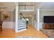 Inviting foyer with hardwood floors, staircase, and wainscoting, creating a grand entrance to the home at 4219 Peachway Dr, Durham, NC 27705
