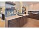 Open kitchen design includes eat-in bar, stainless steel appliances, modern backsplash, and wood floors at 4219 Peachway Dr, Durham, NC 27705