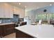 Bright kitchen features a center island with quartz countertops, modern appliances, and a decorative tile backsplash at 4219 Peachway Dr, Durham, NC 27705