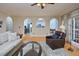 Open-concept living room with hardwood floors, large windows, and arched doorways leading to other rooms at 4219 Peachway Dr, Durham, NC 27705