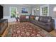 Comfortable living room featuring hardwood floors, ample seating, and natural light from the surrounding windows at 4219 Peachway Dr, Durham, NC 27705