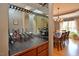 Elegant wine bar with mirrored backdrop, wine glass rack, and adjacent dining area at 4219 Peachway Dr, Durham, NC 27705