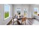 Cozy breakfast nook with hardwood floors, white trim, and a beautiful backyard view at 43 Fountainhead Ln, Garner, NC 27529