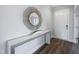Inviting foyer with wood-look flooring, stylish console table, and decorative mirror at 43 Fountainhead Ln, Garner, NC 27529